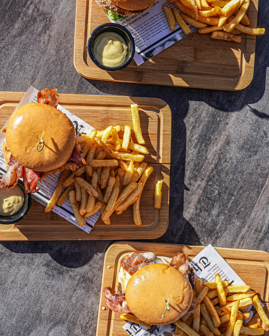 burgers - lunch - taverne - summer - restaurant - meribel A gourmet homemade burger and cold beer served for lunch on the outdoor dining terrace at La Taverne, a bar in Méribel